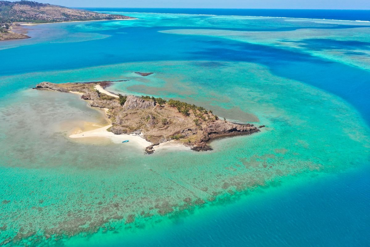 Aerial view of a turquoise lagoon and small island, Fiji