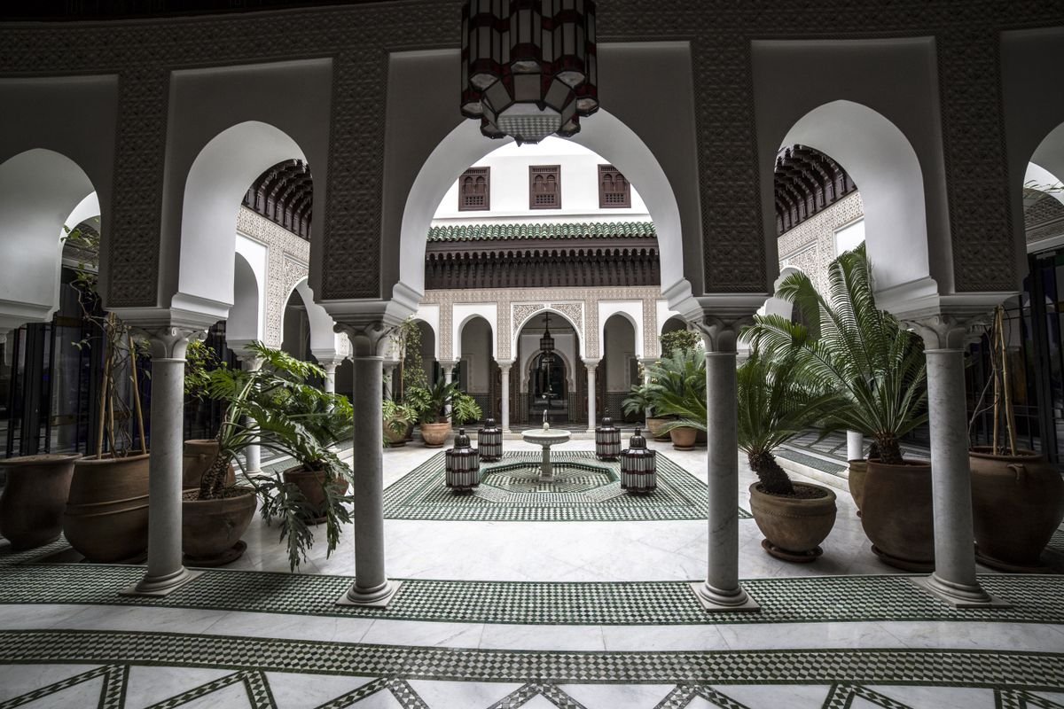 Ornate riad courtyard with arches and a central fountain, Marrakesh